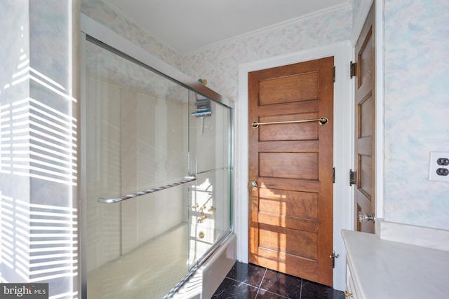 bathroom with vanity, crown molding, and shower / bath combination with glass door