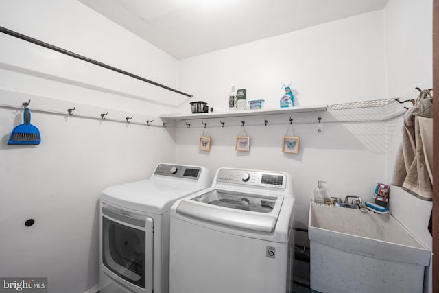 washroom featuring sink and separate washer and dryer