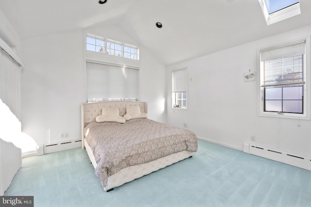 carpeted bedroom featuring a baseboard radiator and lofted ceiling with skylight