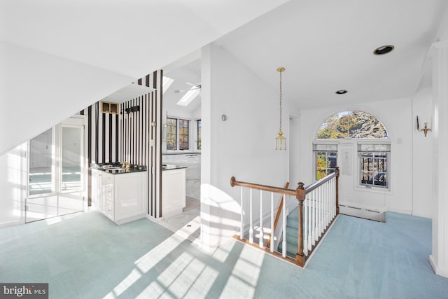 hall featuring a baseboard radiator and a skylight