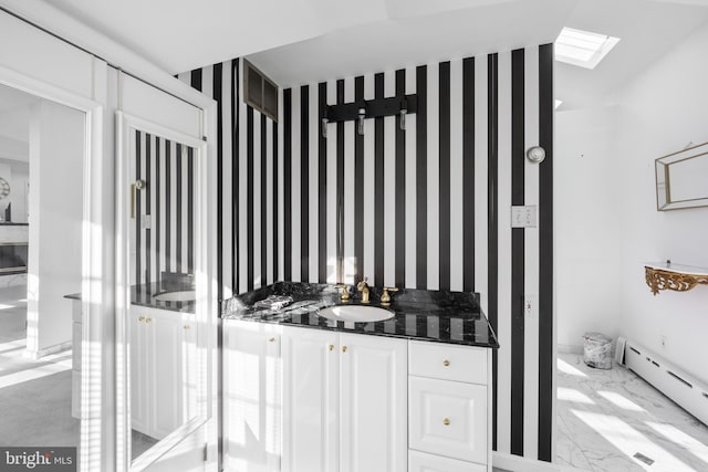 bathroom featuring vanity and a baseboard heating unit