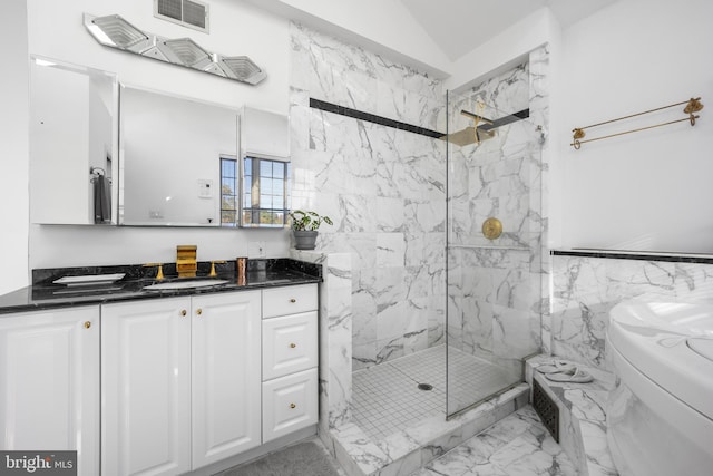 bathroom featuring vanity, a shower with shower door, and toilet