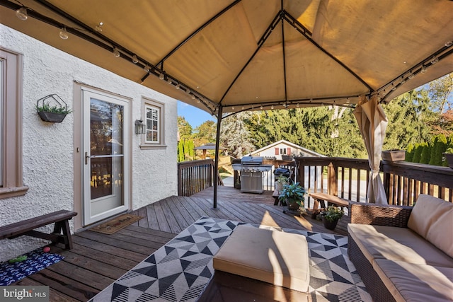 wooden deck with a gazebo and outdoor lounge area