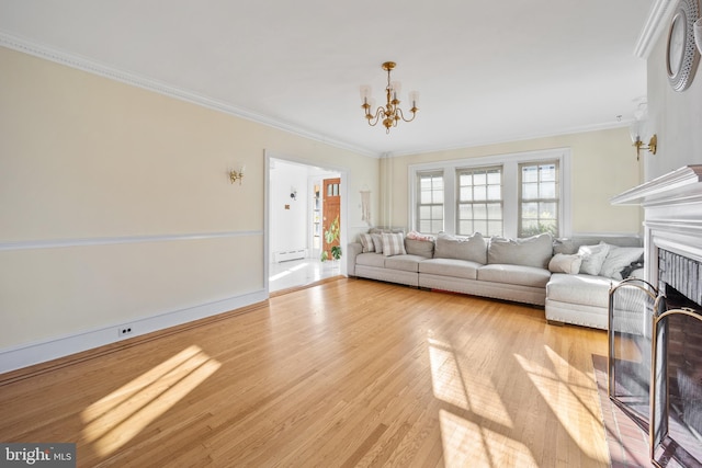 living room with ornamental molding, a chandelier, light hardwood / wood-style floors, and a baseboard radiator