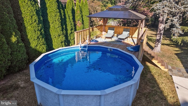 view of swimming pool featuring a gazebo and a deck