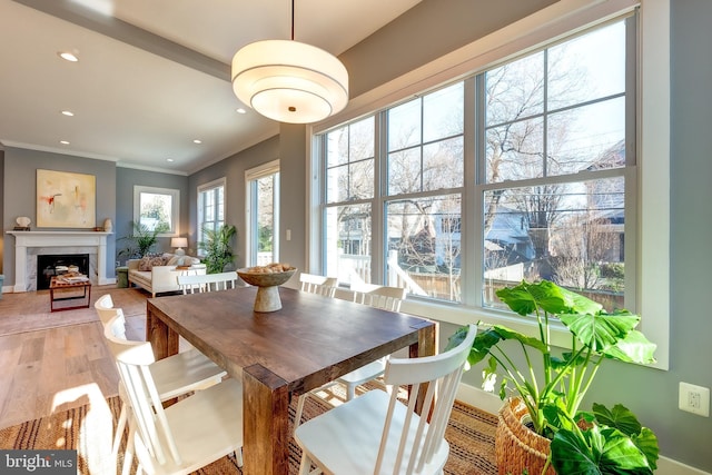 dining space with crown molding and hardwood / wood-style flooring