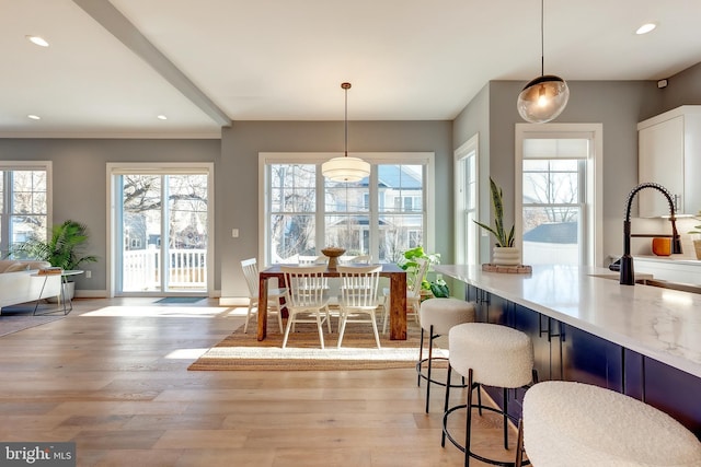 dining room with sink and light hardwood / wood-style flooring