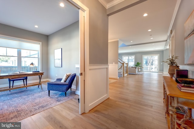 interior space featuring crown molding and light wood-type flooring