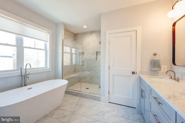 bathroom with vanity and shower with separate bathtub