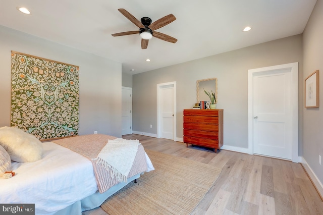 bedroom with light hardwood / wood-style flooring and ceiling fan