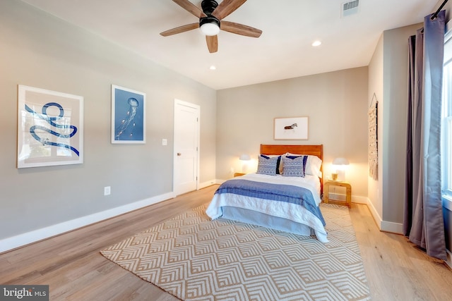 bedroom with ceiling fan and light hardwood / wood-style floors