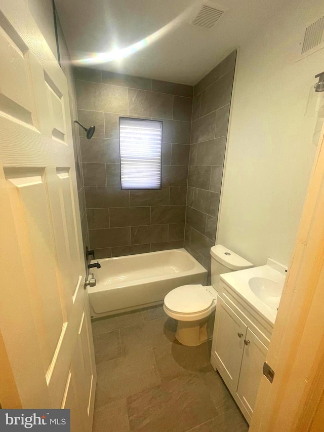 full bathroom with vanity, toilet, and tiled shower / bath combo