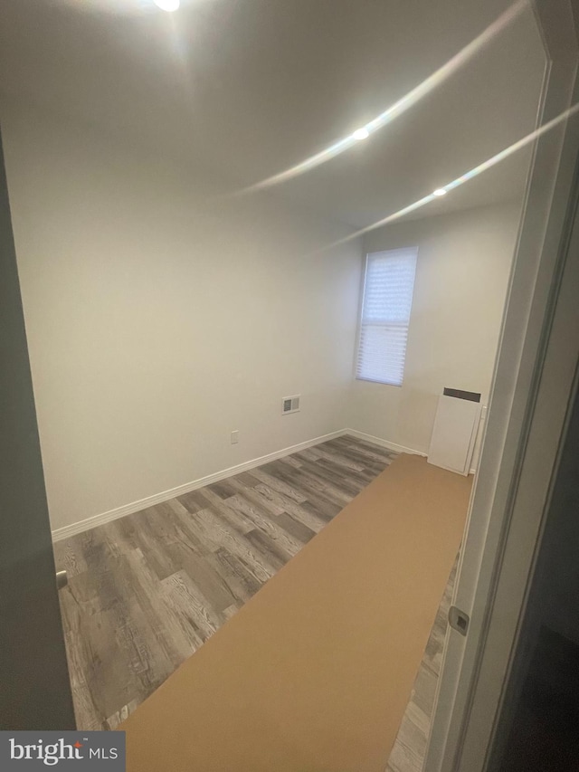 unfurnished room featuring hardwood / wood-style flooring