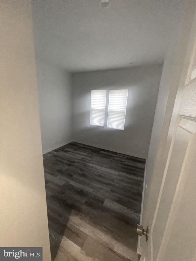 unfurnished room with dark hardwood / wood-style floors