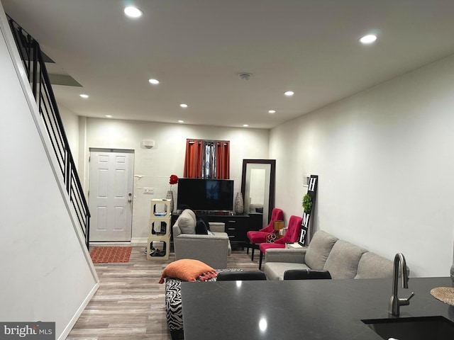 living room featuring sink and light wood-type flooring