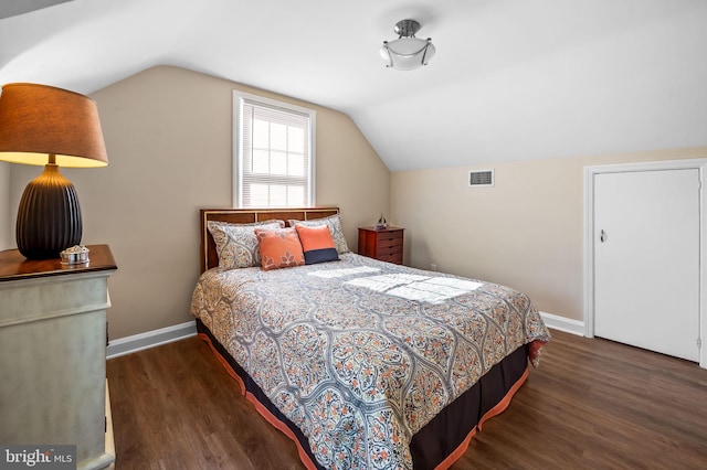 bedroom with dark hardwood / wood-style flooring and vaulted ceiling