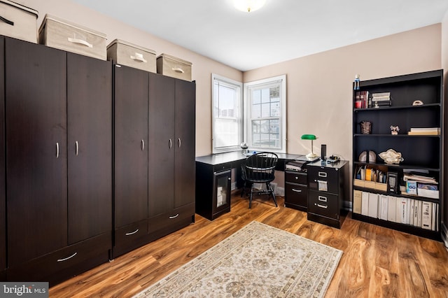 office with light hardwood / wood-style floors