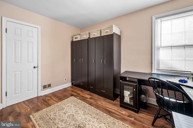 office with dark hardwood / wood-style flooring