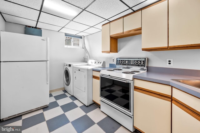 kitchen with a paneled ceiling, electric range oven, white refrigerator, and washing machine and clothes dryer