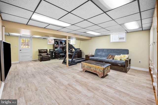 living room featuring a paneled ceiling and light hardwood / wood-style flooring