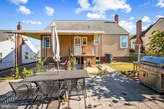 rear view of property with a patio and cooling unit