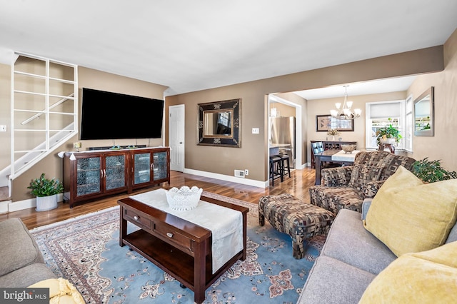 living room featuring hardwood / wood-style floors and an inviting chandelier