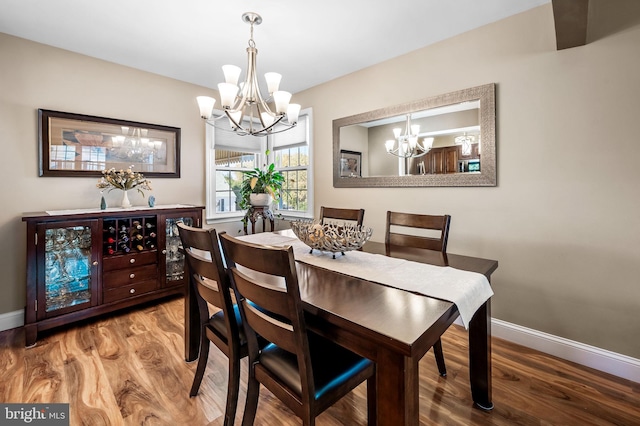 dining area featuring an inviting chandelier and hardwood / wood-style floors