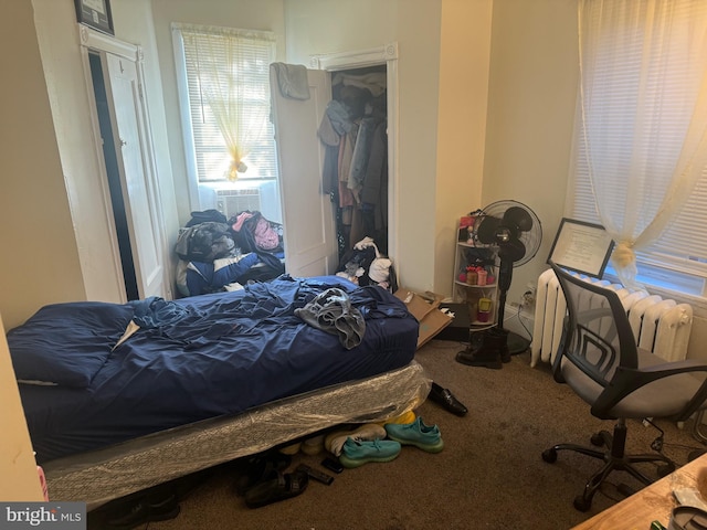 carpeted bedroom featuring cooling unit and radiator