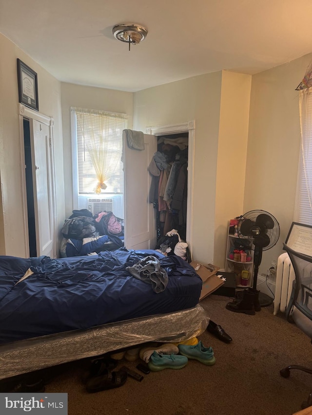 bedroom featuring a closet, carpet floors, and cooling unit