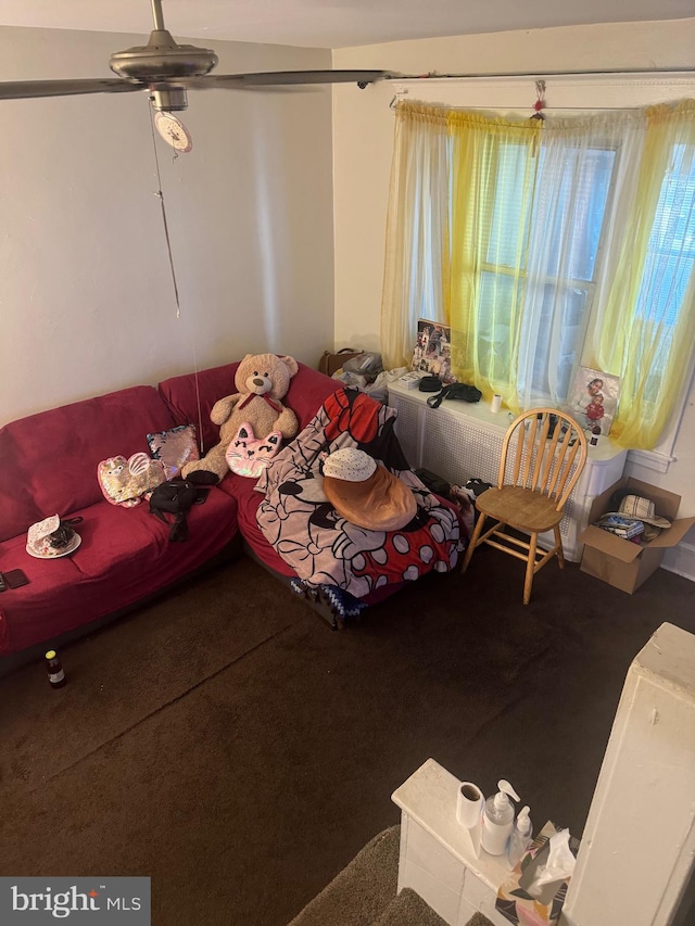 unfurnished living room featuring carpet flooring and ceiling fan