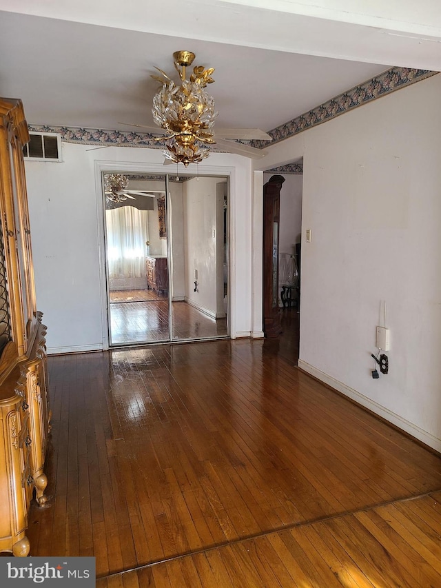 interior space with dark hardwood / wood-style flooring and a notable chandelier