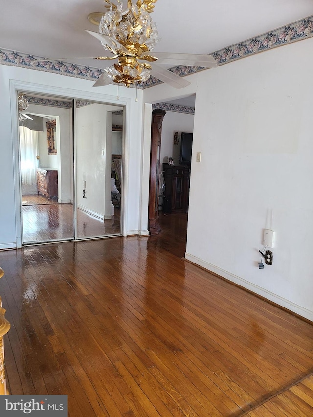 unfurnished room with ceiling fan and hardwood / wood-style floors