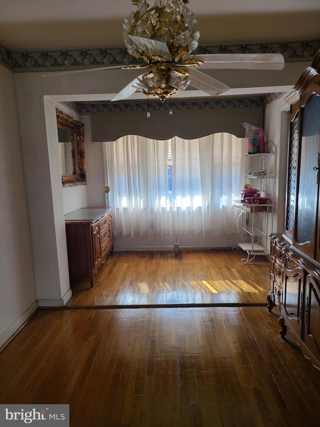 unfurnished dining area with hardwood / wood-style floors, a wealth of natural light, and ceiling fan