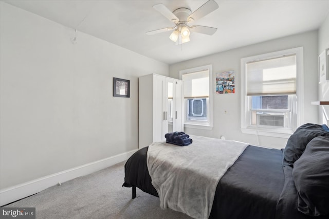 carpeted bedroom featuring cooling unit and ceiling fan