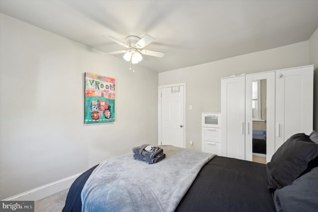 bedroom with ceiling fan and carpet