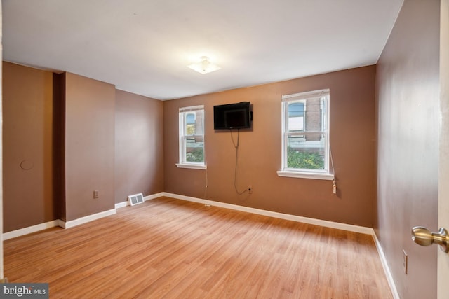 unfurnished room featuring hardwood / wood-style flooring