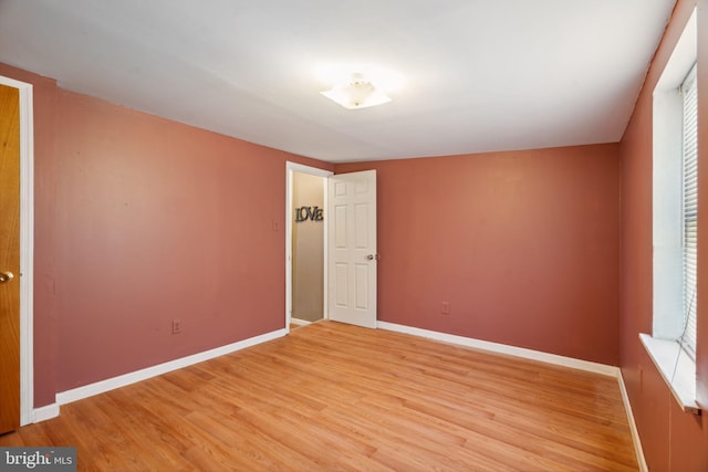 unfurnished room with hardwood / wood-style floors