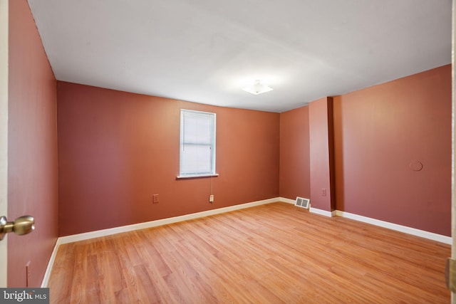 spare room featuring hardwood / wood-style flooring