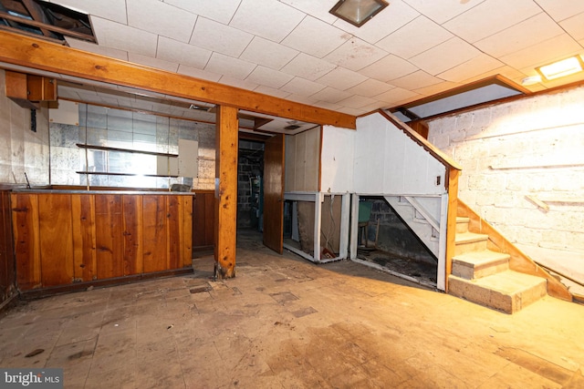 basement featuring wood walls