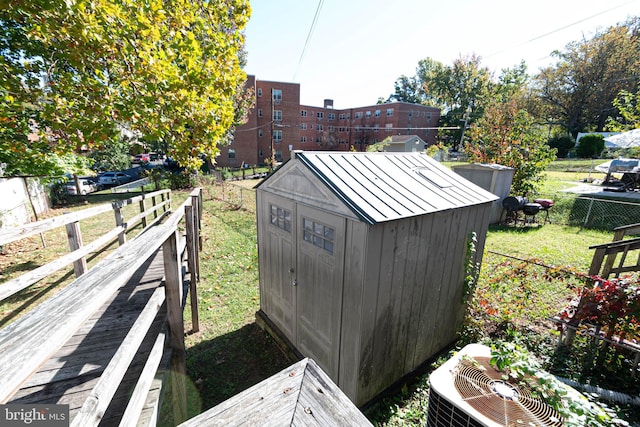 view of outdoor structure with central air condition unit and a yard