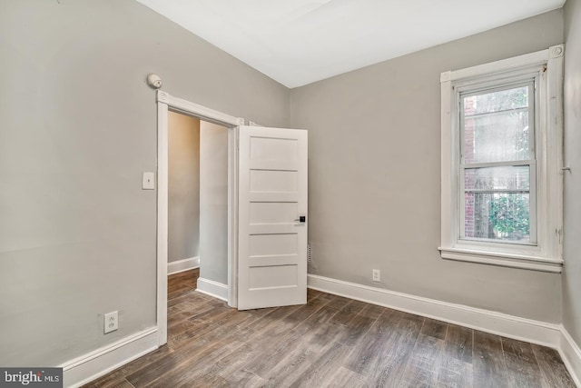 spare room featuring dark wood-type flooring