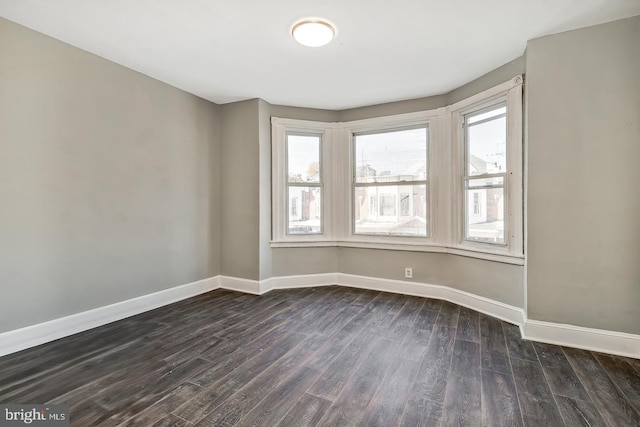 spare room featuring dark wood-type flooring