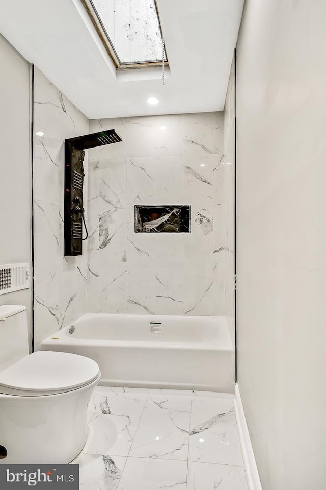 bathroom with toilet, tiled shower / bath combo, and a skylight