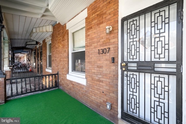 view of exterior entry with a porch