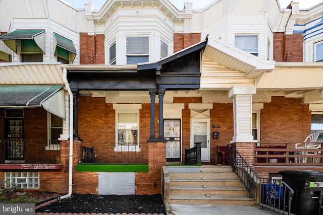 view of exterior entry with a porch