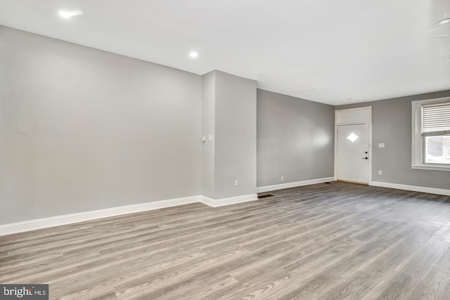 unfurnished living room featuring light wood-type flooring