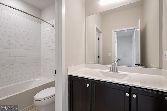 full bathroom with vanity, tiled shower / bath combo, and toilet