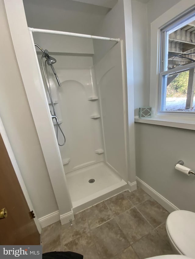 bathroom with toilet and walk in shower