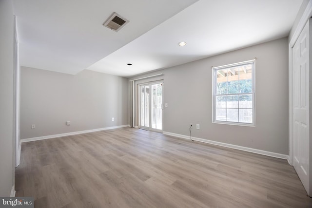 spare room with light hardwood / wood-style floors