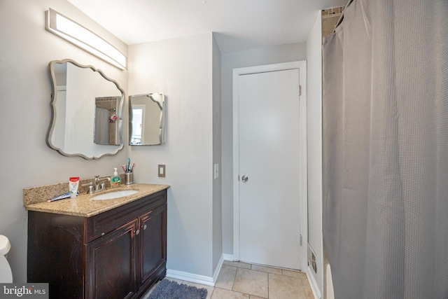 bathroom with vanity, toilet, walk in shower, and tile patterned flooring